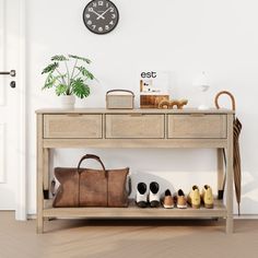 a wooden table topped with a brown bag and lots of shoes next to a clock