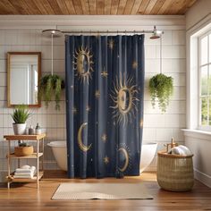 the sun and moon shower curtain is on display in this bathroom with wood flooring