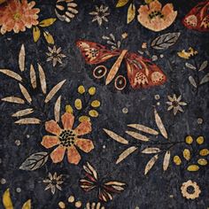 an artistically designed cloth with flowers and butterflies on it's surface, in the middle of which there is a butterfly