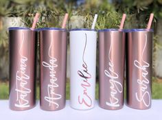 four personalized tumblers with straws in them sitting next to each other on a table