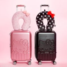 two suitcases with hello kitty decorations on the front and back, side by side