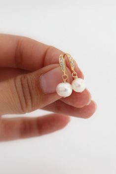 These beautiful gold pearl earrings are perfect for a bride or as a bridesmaids gift at her wedding. These delicate drop earrings are made with small freshwater pearls that are hanging from elegant gold over sterling silver ear hooks with tiny clear cubic zirconia. Very delicate! See last picture for matching Necklace also available in my Shop here: https://www.etsy.com/listing/167948530 These earrings will complement any outfit and will never get out of fashion. Total size of these gorgeous fre Round Bridal Earrings With Ear Wire, Dainty Bridal Earrings For Bridesmaid Gift, Classic Pearl Earrings With Ear Wire For Weddings, Gold Pearl Charm Earrings For Wedding, Pearl White Earrings For Weddings, Dainty Drop Pearl Earrings For Bridesmaids, Pearl White Wedding Earrings With Ear Wire, Delicate Pearl Earrings For Bridesmaid Gift, Dainty Pearl Charm Earrings For Wedding