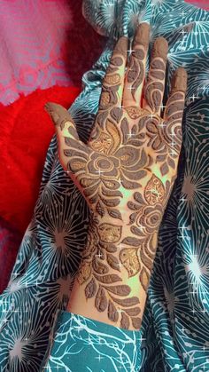 a woman's hand with henna on it