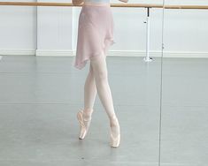 a young ballerina is practicing her moves in the ballet studio