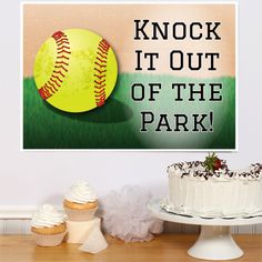 a cake and cupcakes on a table with a sign that says knock it out of the park