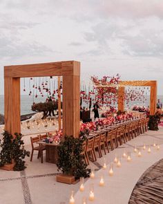 an outdoor wedding setup with candles and flowers