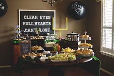 a table filled with lots of food and balloons