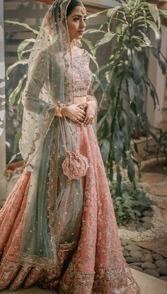 a woman in a pink and green lehenga