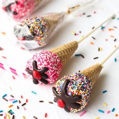 three ice cream cones with sprinkles on them