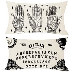 two pillows with hand prints on them, one is white and the other is black