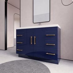 a bathroom with a blue cabinet and mirror on the wall next to a round rug