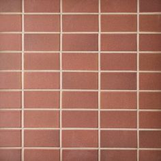 a red brick wall with white and brown squares on it's sides, as well as the bottom half