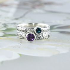 This custom made ring set is made with 2 separate solid sterling silver bands. This listing includes one 4mm gemstones and one 5mm gemstone. The gemstones are set in sterling silver tube bezels. You may choose the bands you love, let me know if you have any questions. Finish: You can choose a classic finish or an oxidized/darkened finish. Gemstones included are listed below. Gems are natural unless otherwise indicated. The last picture shows the gems included in this listing. Some photos shown i Sterling Silver Stackable Rings With Bezel Setting As Gift, Silver Stackable Rings For May Birthstone, Sterling Silver Stackable Rings For Anniversary - May Birthstone, Sterling Silver Stackable Rings For Anniversary, May Birthstone, Silver Stackable Birthstone Ring With Round Band, Silver Stackable Birthstone Ring For Anniversary, Silver Stackable Promise Rings With May Birthstone, Adjustable Sterling Silver Stackable Rings, May Birthstone, Adjustable Sterling Silver Stackable Rings For May Birthstone