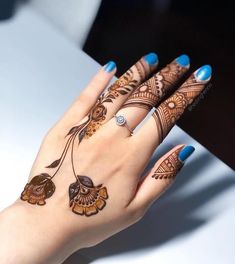 a woman's hand with henna tattoos on it