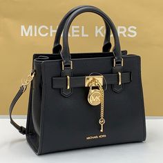 Michael Kors Hamilton Small Satchel Shoulder Crossbody Bag Pebbled Leather Michael Kors Logo At Front Zip Top Closure Gold Toned Hardware Black Color Mk Key & Lock On Front Custom Mk Fabric Lining 1 Slip-In Pockets 1 Zipper Pocket 10" (L) X 8"(H) X 4"(D) Strap: 4", 18"- 24" Very Clean, Smoke-Free And Pet-Free Environment Black Top Handle Satchel With Lock, Black Top Handle Shoulder Bag With Lock, Designer Crossbody Bag With Lock, Elegant Evening Bags With Lock, Classic Crossbody Bag With Lock, Designer Black Shoulder Bag With Lock, Black Office Satchel With Lock, Black Formal Bags With Lock, Black Formal Bag With Lock