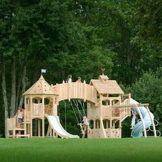 a wooden play set in the middle of a park