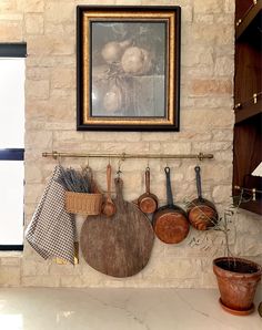 pots and pans are hanging on the wall