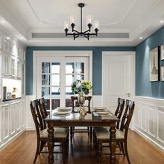 a dinning room with blue walls and wooden flooring is pictured in this image