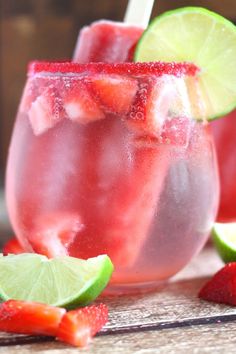 two glasses filled with watermelon and limeade next to strawberries