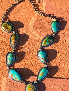 Obviously one of my favorite items to shoot. These necklaces showcase Royston turquoise, the most beautiful mix of ocean blue, forest greens and brilliant copper. Our stones are second to none, we go direct to the mine to choose the stones used to produce these amazing works of art, the best part is we get first choice at the mine! Hand-picked to create a unique, heirloom quality piece that you will enjoy for years to come. Gem quality turquoise set in sterling silver and linked together to lay Unique Turquoise Necklace With Patina, Unique Multicolor Jewelry With Patina, Unique Multicolor Patina Jewelry, Artisan Turquoise Lariat Necklace, Unique Turquoise Lariat Necklace, Nature-inspired Turquoise Jewelry With Large Stone, Turquoise Chrysocolla Necklace With Patina, Bohemian Chrysocolla Necklace With Patina, Blue Forest