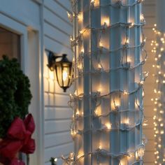 christmas lights are hanging on the side of a house