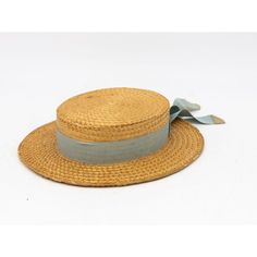 The Ridgemont Make's vintage 1930s boater hat showcases timeless elegance with its natural straw construction. Adorned with a pale blue ribbon and bow, this hat epitomizes classic style. The sturdy yet lightweight straw provides comfort and durability, while the charming ribbon adds a touch of sophistication. This boater hat captures the essence of vintage summer fashion, making it a coveted accessory for collectors and design enthusiasts alike. Seven are available for a display collection. Some Vintage Hat Bands For Beach With Flat Crown, Vintage Blue Adjustable Hat Bands, Vintage Flat Crown Hats For Beach, Vintage Flat Crown Hats For The Beach, Vintage Straw Boater Hat For Garden Party, Vintage Adjustable Boater Hat With Flat Crown, Classic Blue Straw Hat For The Beach, Classic Blue Wide Brim Straw Hat, Vintage Hat Bands With Flat Crown For Summer