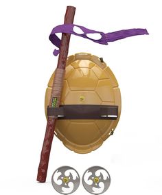 a toy turtle shell with two swords attached to it