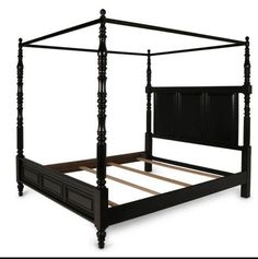 a black bed frame with four posts and no headboard or foot board on an isolated white background