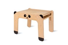 a small wooden stool with a panda face on the front and legs, made out of plywood