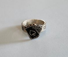 This ring was designed with the black jack hand cards symbol. The beautiful pewter ring is a silver color and the background is blackened to bring out the fine detail of the design. Our rings are 100% Lead and nickel free pewter and made in the USA The top design part of the ring measures approx. 12.5mm x 12mm  The ring band tapers from about 5mm to about 4mm at the bottom and is about 1.5mm thick Picture shows size compared to a US Dime Rings are available in sizes 4 to 7 (half sizes also) Black Jack Cards, Pewter Ring, Black Jack, Ladies Ring, Classy Jewelry, Jewelry Lookbook, Jack Black, Affordable Jewelry, Top Design