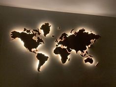 the world map is lit up on the wall