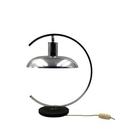 a table lamp that is on top of a white surface with a cord attached to it