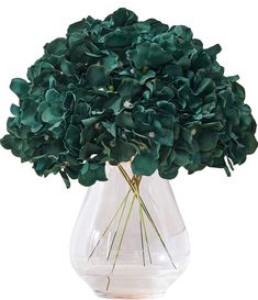 a vase filled with green flowers on top of a table