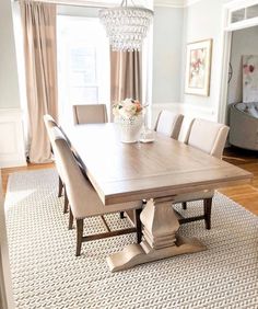 a dining room table with chairs and a chandelier