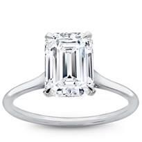 an emerald - cut diamond ring on a white background