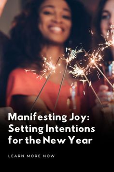 two women holding sparklers with the caption saying, manefesting joy setting intentionss for the new year learn more now