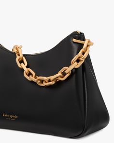 Sport a handbag that stands out with the black Grace Chain Shoulder Bag from kate spade new york. The Grace style is timeless and classic, finished with sleek fine grain black leather. This handbag's gold chain strap is what makes it unlike all the other black handbags out there, making it go from just versatile to versatile and unique. Wear it over the shoulder with any outfit for any occasion. Take on your days with grace wearing the Grace Chain Shoulder Bag from kate spade new york! Elegant Formal Bag With Chain Link, Elegant Everyday Chain Link Shoulder Bag, Formal Shoulder Bag With Gold Chain Link, Elegant Chain Link Shoulder Bag For Everyday, Formal Shoulder Bag With Gold Chain, Elegant Bags With Chain Link And Metal Hardware, Modern Bags With Gold Chain, Modern Kate Spade Evening Shoulder Bag, Modern Chain Link Shoulder Bag For Evening