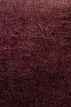 an area rug that has been made to look like it is covered in dark red velvet