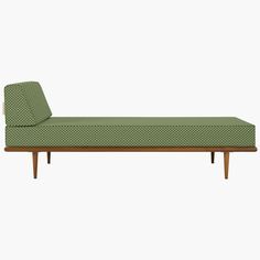 a green chaise lounger sitting on top of a white floor