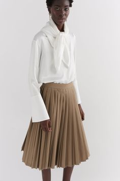 Our Khaki contrast pleated skirt is made of 100% wool, woven in Yorkshire at the mill Alfred Brown. The skirt is hand pleated in London. The skirt features two contrast pleats and a side entry invisible zip. Plated Skirt, Knife Pleated Skirt, Pleats Skirt, Knife Pleat, Tailored Coat, The Mill, Ivory Silk, Khaki Dress, Invisible Zip