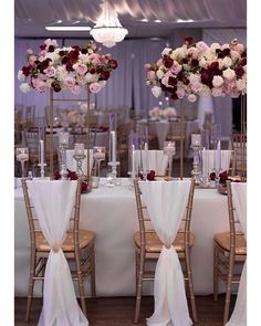 the tables are set with white linens and flowers