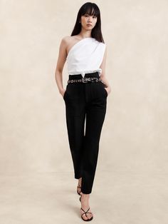 A classic pant, cut here in a high-rise slim silhouette with utilitarian top-stitch detailing.  For fabric, our designers selected a bi-stretch woven from LENZING™ ECOVERO™, beloved for its softness, high-stretch and dressed-up appearance.  SLIM FIT: High rise.  Slim through hip and thigh, gentle taper from knee to hem.  SUSTAINABILITY: Made with LENZING™ ECOVERO™, a breathable fiber derived from certified renewable wood sources, produced using methods that reduce water impact and emissions by up to 50% compared to traditional viscose.  Zip fly with hook-and-bar closure.  Belt loops.  Detachable belt.  Front pockets.  Back pockets.  Unlined.  Slim fit: High rise (9. 75").  Slim leg.  Tapered ankle.  Full length.  Inseams: Short 25", Regular 27", Tall 30" Model: Size 25, 5'10" (178cm). Classic Pants, Utility Pants, Black Camo, Bottom Clothes, Slim Legs, Petite Size, Bottoms Pants, Black Pants, Banana Republic