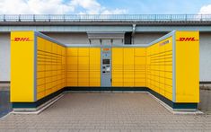 a yellow and gray building with a payphone in it