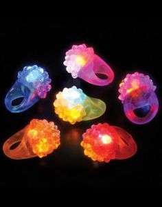 glow in the dark finger rings with different colors and sizes are shown on a black background