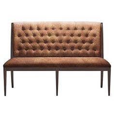 a brown couch sitting on top of a wooden frame