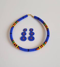 100% handmade using fine beads. Details: *Necklace comes with matching earrings. *Necklace length: 18 inches around the neck. Earrings -3 inches long. *Ships via Dhl express. **Buy multiple items and pay shipping for one item Only. More neckleces here; https://www.etsy.com/shop/TribalTess?ref=seller-platform-mcnav&section_id=21306083 Back to my shop; https://www.etsy.com/shop/TribalTess?ref=seller-platform-mcnav Blue Round Beaded Necklaces With Colorful Beads, Blue Beaded Necklaces With Colorful Beads, Blue Beaded Earrings With Polished Beads As Gift, Blue Beaded Earrings As Gift, Blue Polished Beaded Earrings For Gifts, Traditional Blue Multi-strand Beaded Necklaces, Orange Multi-strand Beaded Necklaces, Blue Multi-strand Beaded Necklaces For Gifts, Cheap Orange Multi-strand Necklaces