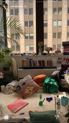 a living room filled with lots of furniture and books on top of a white floor