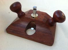 a wooden object with two knobs on it