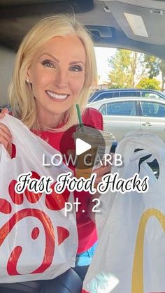 a woman sitting in the back seat of a car holding up two bags with fast food hacks on them