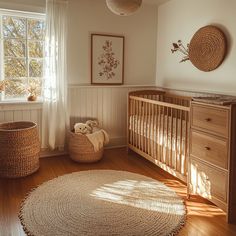 a baby's room with white walls and wood floors